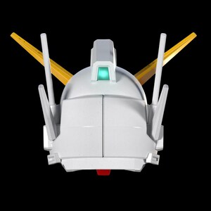 May include: A white robot head with yellow and white accents, and a red detail at the bottom. The head has a rounded top with a rectangular structure and a green light. Two yellow fins extend from the sides.