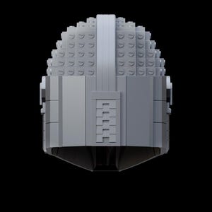 May include: A gray helmet constructed from interlocking toy bricks, set against a black background. The helmet features a rounded top and a rectangular visor area. The design is symmetrical, with a central vertical ridge.