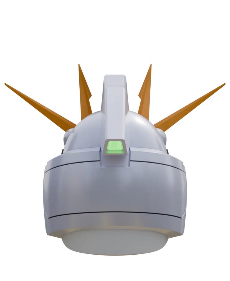 May include: A detailed, close-up view of a white and gray robotic helmet with orange accents. The helmet features a prominent crest and several pointed orange protrusions. A small, green rectangular detail is visible.