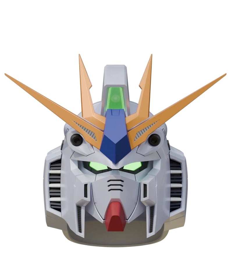 May include: A detailed, close-up of a robot head, primarily white with orange, blue, and green accents. The robot's eyes glow green, and it has a red chin. The design is futuristic and mechanical, with sharp angles and intricate details.