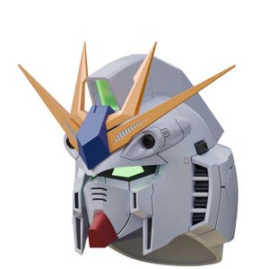 May include: A detailed, light gray Gundam head model with gold and blue accents. The model features a red chin, green glowing eyes, and multiple vents and panels. The head has two prominent gold V-fins.