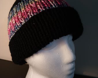 May include: Black knit beanie with a colorful stripe pattern. The beanie is on a white mannequin head.