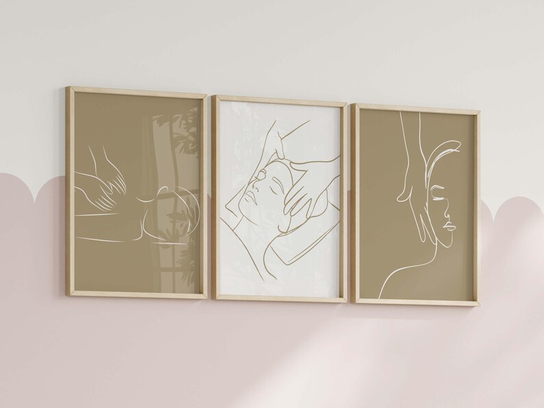 May include: Three framed illustrations of line drawings of people receiving a facial massage. The illustrations are in a minimalist style and are printed on a beige background.