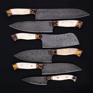 Custom Handmade Damascus Steel Chef Knife Set, crafted for top-tier kitchen performance. Each knife boasts a stunning wave pattern on the blade, paired with an ergonomic bone handle for comfort and control. This set is perfect for culinary professionals, BBQ enthusiasts, and home chefs who value quality and craftsmanship. A great personalized gift for groomsmen, anniversaries, or special occasions.
