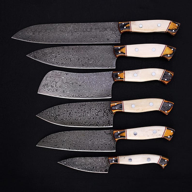 Elegant Damascus Steel Chef Knife Set, handmade with high-carbon Damascus steel and a polished bone handle. Designed for both professional chefs and home kitchens, these knives offer superior sharpness and precision. Whether you're chopping, slicing, or dicing, this set provides a seamless cooking experience. A perfect wedding, anniversary, or groomsmen gift for those who appreciate quality.