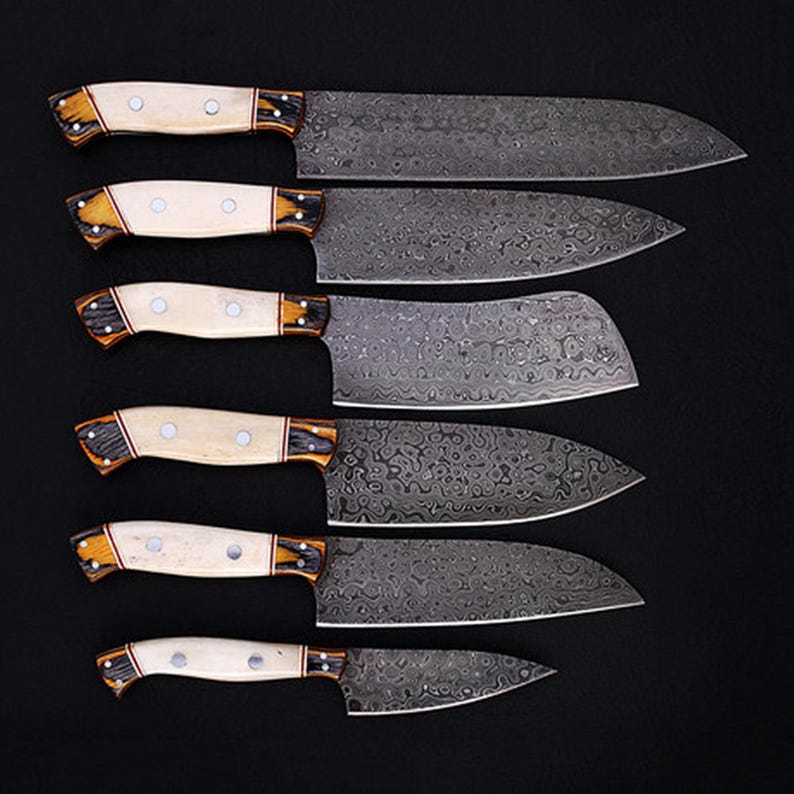 Handmade Damascus Steel Chef Knife Set with Bone Handle, perfect for professional and home chefs. This custom kitchen knife set offers razor-sharp precision, durability, and a stunning aesthetic. Ideal for slicing, dicing, and chopping, making it a great addition to any kitchen or restaurant. A unique personalized gift for weddings, groomsmen, anniversaries, or cooking enthusiasts.