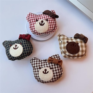 May include: A white ceramic mug with a black handle and the text "But First, Coffee" in a bold, black font. The mug is set against a neutral background, highlighting its simple design.