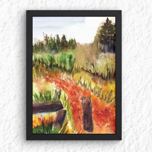 May include: Watercolor painting of a landscape scene in a black frame. The artwork depicts a field with tall green and yellow grass, a path of orange and red foliage, and a wooden fence. Trees are visible in the background under a light blue sky.