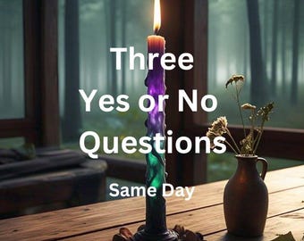 May include: A lit, multi-colored candle with the text "Three Yes or No Questions Same Day" on a wooden table. A small vase with dried flowers sits to the right of the candle. The background shows a blurred forest scene.