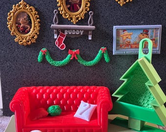 May include: A miniature Christmas-themed diorama featuring a red sofa, a green Christmas tree, and framed pictures. A snowman, a green garland, and a small shelf with a stocking are also present. The pictures feature a lizard wearing a Santa hat.