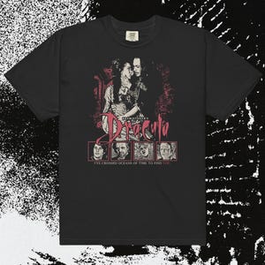 May include: Black t-shirt featuring a graphic from Bram Stoker's Dracula. The design includes a romantic image of a couple, the title "Dracula", and portraits of characters. The text "I've crossed oceans of time to find you" is also included.