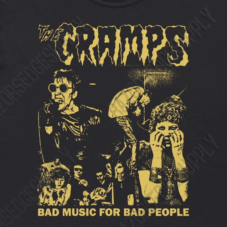 May include: A black and yellow graphic t-shirt featuring a band called "The Cramps" with the text "Bad Music For Bad People".