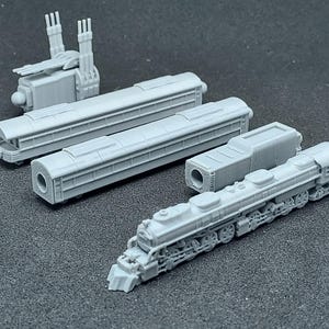 May include: A collection of gray miniature train models, including a locomotive, passenger cars, and a separate engine component. The models are detailed and appear to be 3D-printed, showcasing various train car designs.