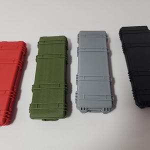 May include: Four hard plastic cases in different colors: red, green, gray, and black. The cases are all the same size and shape, and they have a rectangular design with a series of raised lines.