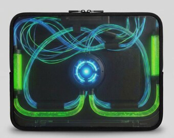 May include: Black laptop sleeve with a futuristic design. The sleeve features a central glowing blue circle, with green and blue lines and tubes. The design gives the impression of a high-tech, energy-based system.