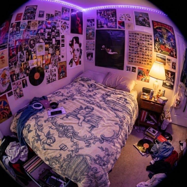 May include: A bedroom with a bed covered in a cream-colored blanket with a blue cherub design. The walls are adorned with posters and album covers, and a lamp sits on a nightstand. A purple LED strip lights the room.