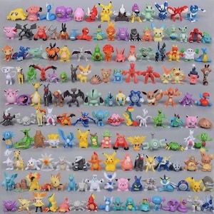 May include: A large collection of small, colorful plastic character figurines arranged in neat rows. The set includes various creatures with distinct shapes, colors, and features, such as pointed ears, wings, tails, and unique facial expressions.