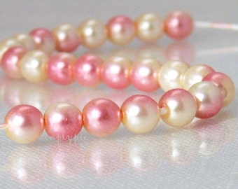 May include: Strands of faux pearls in shades of pink and cream. The pearls are strung together, creating a delicate and elegant appearance. The pearls have a subtle sheen, reflecting light and adding a touch of sophistication. The image is a close-up, highlighting the details of the beads.