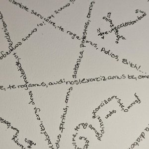 May include: A handwritten image with a star shape formed by three overlapping circles. The circles are filled with words in a spiral pattern. The words include "satanica", "adversarii", "omnis", "exorcizamus", "te rogamus", "audinos", "potes", "rogae", "servi", "libertate", "ecclesiam", "adios", "bitch", "immunculus", "pirthus", "amnis", "satanica", "exorcizamus", "te", "omnis", "undus", "spiritus", "amug", "nadiabdica", "erga", "alrace", "comaledicte", "ut", "ecclesian", "estas", "oms", "gilighe", "dinos".