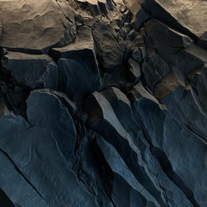 May include: Close-up of a dark grey rock formation with sharp, jagged edges and deep crevices. The texture is rough and uneven, creating a dramatic and abstract pattern.