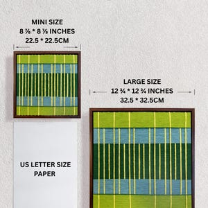 May include: Two square framed wall art pieces featuring vertical and horizontal stripes in lime green, dark green, and light blue. The mini size is 8 7/8 by 8 7/8 inches, and the large size is 12 3/4 by 12 3/4 inches, shown next to US letter paper.
