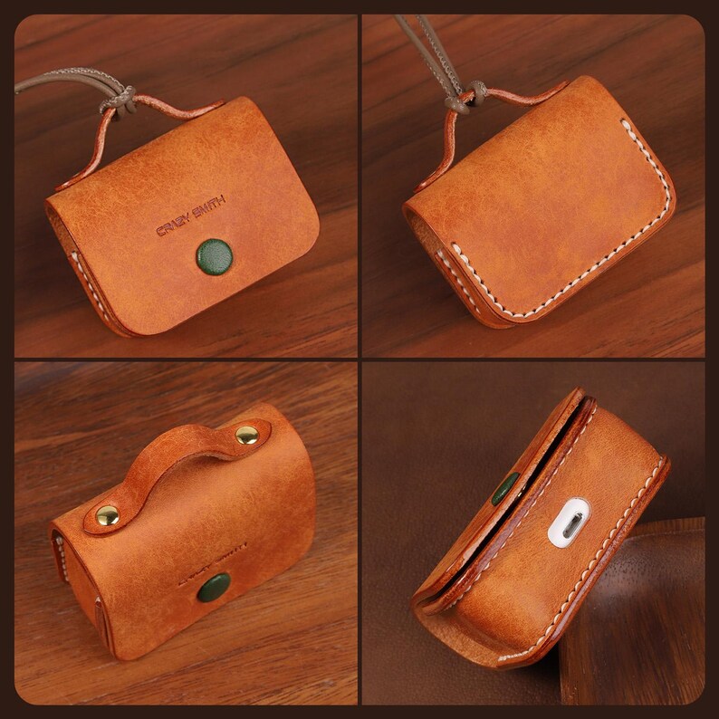 May include: A tan leather protective case for wireless earbuds featuring a flap closure with a green snap button, white contrast stitching, and a leather carrying strap. The text CRAZY SMITH is embossed on the front. A charging port is visible.