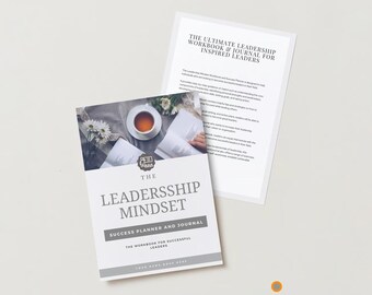May include: A gray and white journal with the title "The Leadership Mindset: Success Planner and Journal" and the subtitle "The Workbook for Successful Leaders". The cover features a cup of tea, a book, and flowers.