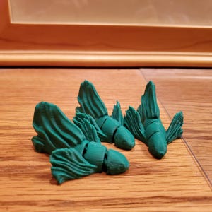 3d printed fish, beta fish figurine, mini fish sculpture, pocket size decor, articulated fish model, realistic fish toy, cute fish.