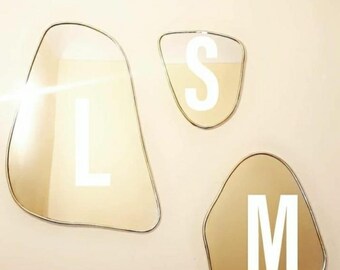 Asymmetrical brass mirror. Irregular brass mirror