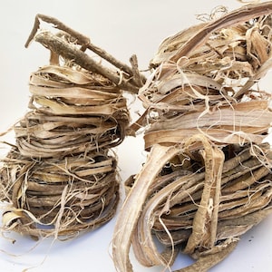 May include: Two bundles of dried, light brown bark, twisted and layered, resembling natural rope or twine. The bark is fibrous and has a rough texture.