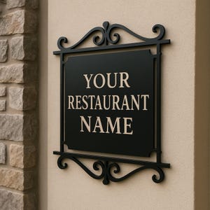 May include: Black rectangular restaurant sign with the text "YOUR RESTAURANT NAME" in a serif font. The sign is framed by a decorative black metal border with scrollwork at the top and bottom.