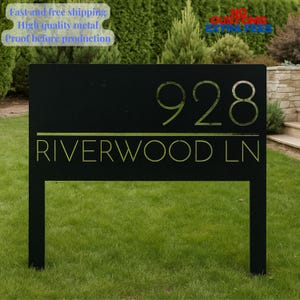 May include: Black metal address sign with the number 928 and the street name RIVERWOOD LN in a gold color. The sign is mounted on two black posts and set in a grassy yard.