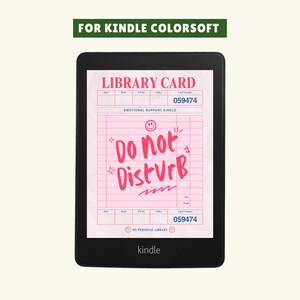 May include: A black Kindle e-reader displaying a pink library card design with the text "Do Not Disturb." The card includes the text "Emotional Support Kindle" and the number 059474. The top of the image reads "For Kindle ColorSoft."