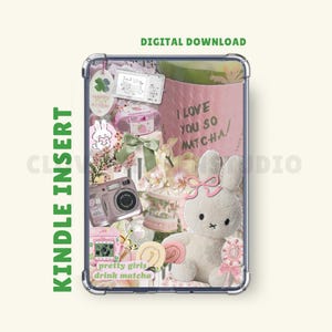 May include: A Kindle insert featuring a collage of pastel-colored elements. Includes a plush bunny, a pink cup with "I love you so matcha" text, a camera, and other decorative items. The words "pretty girls drink matcha" are also visible.
