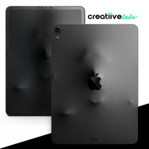 May include: Black iPad with a textured, wrinkled, or crinkled surface. The Apple logo is visible on the back of the device. The iPad is in a landscape orientation.
