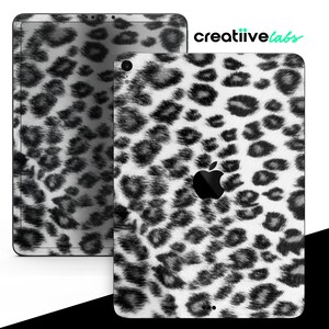 May include: Two tablets with a black and white leopard print design. The tablets are in different sizes, with the larger one on the left and the smaller one on the right. The Apple logo is visible on the smaller tablet. The text "creatiivelabs" is in the upper right corner.
