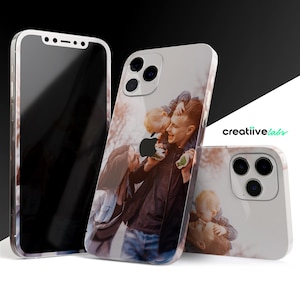 May include: Three white iPhone cases with a photo printed on the back. The photo shows a family of three, a father, mother, and a young child. The photo is in a warm color tone.