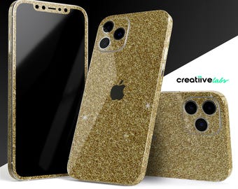 May include: Gold glitter iPhone cases and screen protector. The cases feature a sparkly, textured surface and a cutout for the Apple logo. The screen protector is black. The brand name "creatiivelabs" is visible.