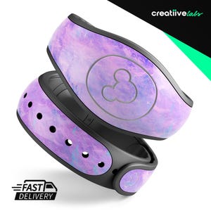 May include: Purple and blue galaxy-themed Disney MagicBand featuring a Mickey Mouse icon. The band is made from durable silicone and is compatible with Disney parks.
