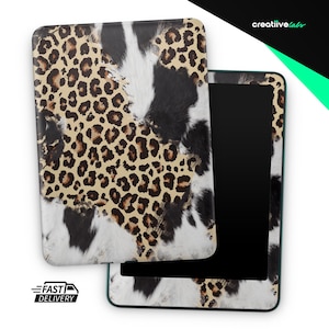 May include: A tablet case with a leopard print design, featuring tan and brown spots on a cream background, contrasted with black and white cowhide-like patterns. The case is open, revealing the black screen. The text "creatiivelabs" is visible.