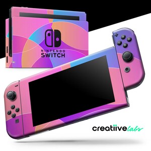 May include: A Nintendo Switch console and controllers with a colorful abstract design in pink, purple, blue, and orange. The console and controllers have a geometric pattern. The Nintendo Switch logo is visible on the console.