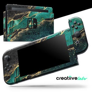May include: A Nintendo Switch console and dock with a custom skin featuring a teal, black, and gold marble design. The Joy-Con controllers are also covered in the same pattern. The console is displayed on a white background.