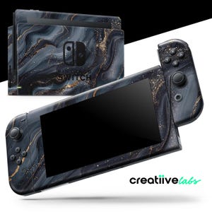 May include: A Nintendo Switch console and controllers with a black and gold marble design. The console and controllers are decorated with a swirling pattern of black, gray, and gold, giving them a luxurious look. The Nintendo Switch logo is visible.