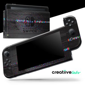 May include: A black Nintendo Switch console and controllers with a glitch art design. The console and controllers have a dark, textured finish with colorful horizontal lines and the Nintendo Switch logo.