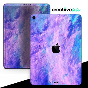 May include: Purple, blue, and pink abstract design iPad skin with a black Apple logo. The skin is designed to fit the iPad Pro.