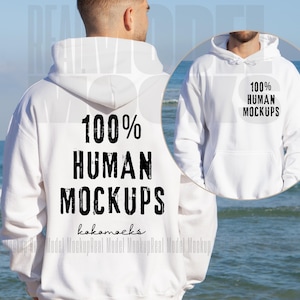 以下が含まれることがあります： 白のフード付きスウェットシャツに、黒で「100% HUMAN MOCKUPS」という文字がプリントされています。文字は、使い古したようなヴィンテージな雰囲気です。