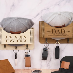 May include: Two wooden key and hat holders. One is light-colored with the word "DAD" and the names Reginald & Audrey & Michael. The other is brown with "BEST DAD EVER" and the names Love, Humbert & Justin.