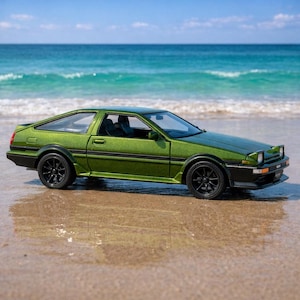 May include: A green sports car with black wheels is parked on a sandy beach with the ocean in the background. The car has a sleek design and a metallic finish, reflecting the sunlight. The car is a classic model.