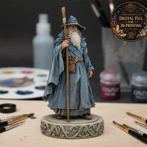 May include: A detailed figurine of a wizard in a blue robe and hat, holding a staff. The wizard has a long white beard and is standing on a decorative base. The image includes text that says "DIGITAL FILE FOR 3D PRINTING".