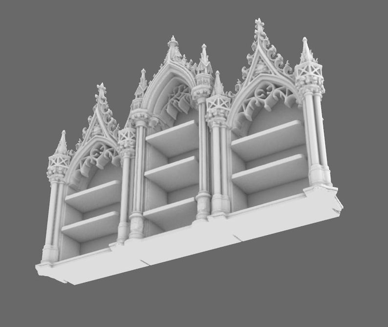 May include: A white, ornate bookshelf with a gothic architectural design. The bookshelf features multiple shelves and decorative arches, columns, and spires. The overall design is symmetrical and detailed, with a focus on intricate patterns and shapes.